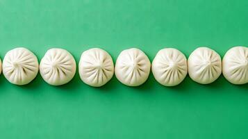 Elegant Steamed Dumplings on a Vibrant Green Background photo
