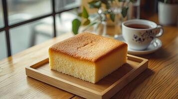 A Perfect Square Cake with a Cup of Tea photo