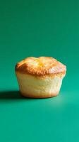 A Delectable Single Cupcake on a Green Background photo