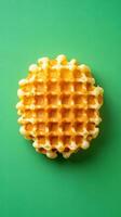 Golden Crispy Waffle on Green Background photo