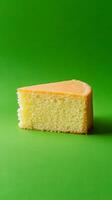 A Slice of Delightful Cake on a Green Background photo