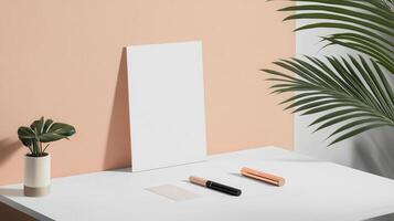 White desk with a plant and pen on it photo