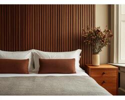 Luxurious hotel style bedroom featuring wooden accent wall, cozy bedding, and stylish decor. warm tones create sophisticated and inviting atmosphere photo