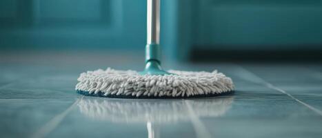 close up of mop gliding across glossy tiles, showcasing its cleaning action and shine of surface. vibrant background adds fresh feel to cleaning process photo
