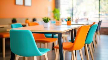 vibrant co working space featuring colorful chairs and bright orange wall, creating inviting atmosphere for collaboration and creativity photo