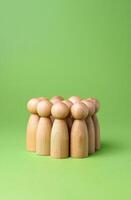 A group of human figures on a green background. Minimalism. Sociology and sciences. Human resources. Recruiting workers and hiring employees. Consumers and marketing. photo
