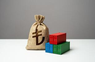 Stack of shipping containers and turkish lira money bag. Import or export. Production of containers. Trade, economics and transport industry. Tariffs and tax collections. GDP and production. photo