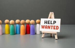 Queue and help wanted sign. Job candidates. Simplification of procedures for accepting foreign workers. Opening of new jobs. Attract investors who provide financial support. Hiring workers photo