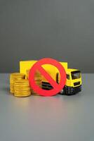 Truck with money and prohibition symbol. Freight restrictions. Transit ban. Sanctions. Truck with coins and red no sign. Embargo. Interference with trade routes, threat logistics. photo