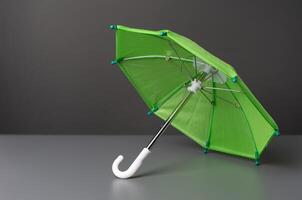 Green umbrella on a sign. Insurance and protection concept. Coverage for areas of risk, including life, health, auto, home, business insurances. Insurance products services. photo
