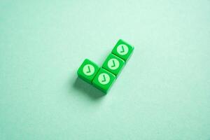 Green checkmark made of blocks with small checkmarks. Divide the work into parts for its easy execution. Concept of planning and dividing the work. photo