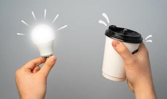 Glowing light bulb and paper coffee cup. Concept of an idea. Take a break and get inspired for a new idea. Talent for coming up with new things and innovative approaches. Creativity and inspiration. photo
