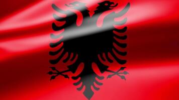 Albania flag in close up moves in waves in the wind with reflecting light on the smooth silky surface. video