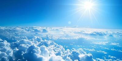 Bright sunlight shining over a sea of fluffy white clouds with a vivid blue sky photo