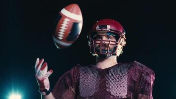 An American football player practicing throwing and catching the ball on a field video