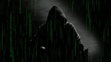 Anonymous man in a hood interview footage. Mysterious man sitting on a chair and talking. Anonymous hacker interview with no visible face, computer hacker conceptual background video