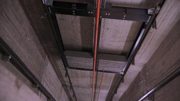 Elevator shaft with guide rails and cables video