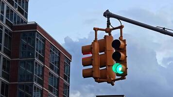 Traffic Light and Building, A green traffic light with a modern building and cloudy sky in the background video