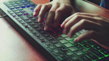 A man types text on a backlit keyboard 01 video