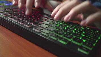 A man types text on a backlit keyboard 03 video