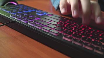 A man types text on a backlit keyboard 02 video