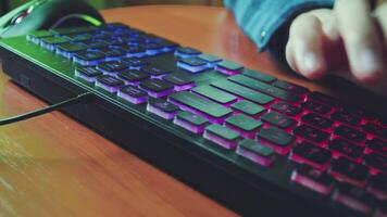 A man types text on a backlit keyboard 04 video