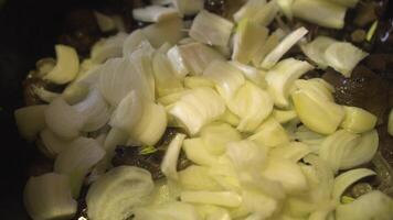 Cook slices onions in a pan with mushrooms 04 video