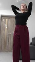 A dancers movements seamlessly combine strength and elegance. The minimalist background enhances each pose, highlighting the fluidity of the performance. video