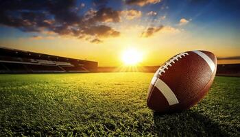 A football is placed on a green field with a beautiful sunset in the background photo