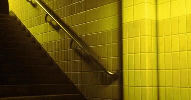 Stairs illuminated by warm yellow light in a public building setting video