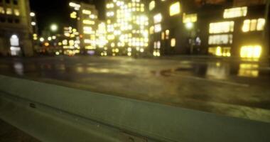 Nighttime cityscape illuminated by colorful lights reflecting on wet pavement video