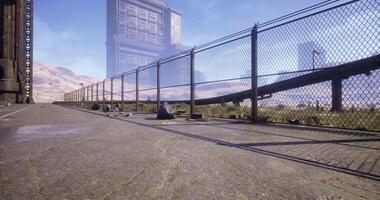 View of a deserted industrial area with a fence and abandoned structures video