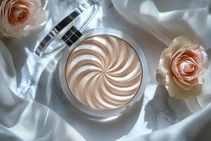 Sparkling champagne toned highlighting powder subtle shimmer is beautifully displayed in sleek compact accentuated soft light reflections and surrounded roses on white surface photo