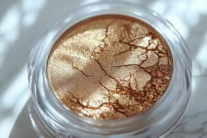 Champagne toned highlighting powder shows subtle shimmer in elegant compact. Light reflections enhance its luxurious appeal against pristine white backdrop photo