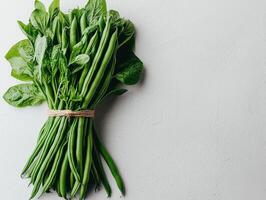 bundle of fresh green beans is presented pristine white background highlighting their smooth texture and bright color perfect for culinary inspiration and healthy eating photo