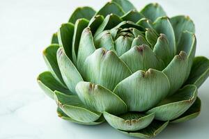 Fresh artichoke displayed in close up emphasizes its intricate green and purple tinted leaves. white background enhances artichoke's natural beauty and unique patterns photo