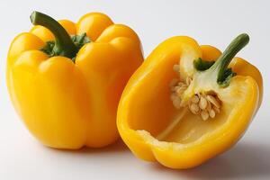 halved yellow bell pepper showcases its smooth and glossy texture revealing its hollow interior and seeds while resting on clean white background adding cheerful visual appeal photo
