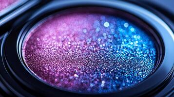 close up captures holographic eyeshadow compact featuring shimmering pink blue and silver hues. Soft lighting enhances futuristic design against sleek white background photo
