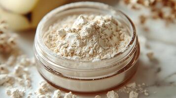 Loose banana powder is showcased in jar soft yellow hue. powder's fine texture captures light beautifully emphasizing its freshness against crisp white background photo
