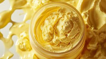 Loose banana powder fills clear jar showcasing fine texture glows soft light against bright white backdrop. surface features gentle dusting of powder photo