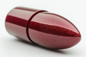 captivating macro shot reveals twisted bullet lipstick in striking deep crimson shade. smooth creamy texture reflects light making vibrant color stand out on clean white background photo