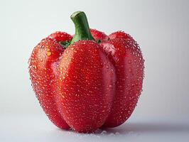 bright red bell pepper stands out dewdrops adorning its surface highlighting freshness and juiciness in modern minimal setting white backdrop photo