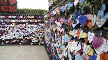 Close-Up of Colorful Heart-Shaped Love Locks Hanging on a Metal Fence in a Romantic Outdoor Display with Soft Depth of Field photo