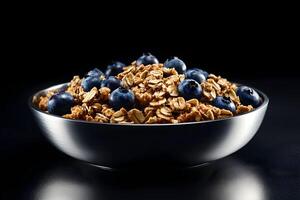 Granola with blueberries in a bowl on a black background photo