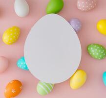 Spring pattern composition made of colorful Easter eggs on pastel pink background with paper card note copy space. Minimal Easter concept. Creative festive holiday layout. Easter aesthetic. Flat lay. photo