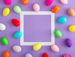 Trendy spring composition pattern made of colorful Easter eggs on purple background with copy space. Minimal Easter concept. Creative festive holiday layout. Easter aesthetic. Flat lay, top of view. photo