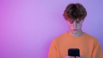 Pensive Teen Boy Using Smartphone Against Gradient Pink and Purple Background Reflecting Teenage Digital Era and Emotional Complexity photo