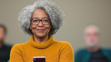 Seniors Engaged in Technology Workshop Learning Smartphone Use, Featuring a Smiling Woman in a Cozy Orange Sweater photo