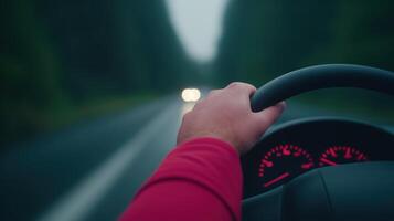 Driver's Hand on Steering Wheel with Car Gauges Illuminated on Blurred Road at Dusk, Capturing Motion and Speed for Dynamic Transportation and Travel Concepts in Stock Photography photo
