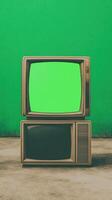 Vintage Televisions with Green Screen Display and Retro Vibe Creative Nostalgic Tech Design for Media Projects and Artistic Expressions in Vibrant Green Background with Copy Space photo